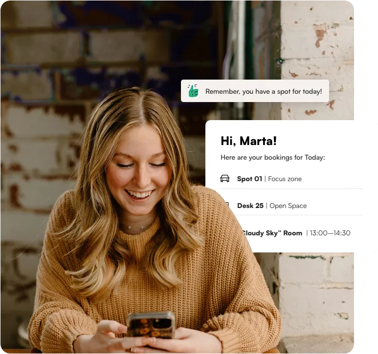 woman with phone using workplace booking app